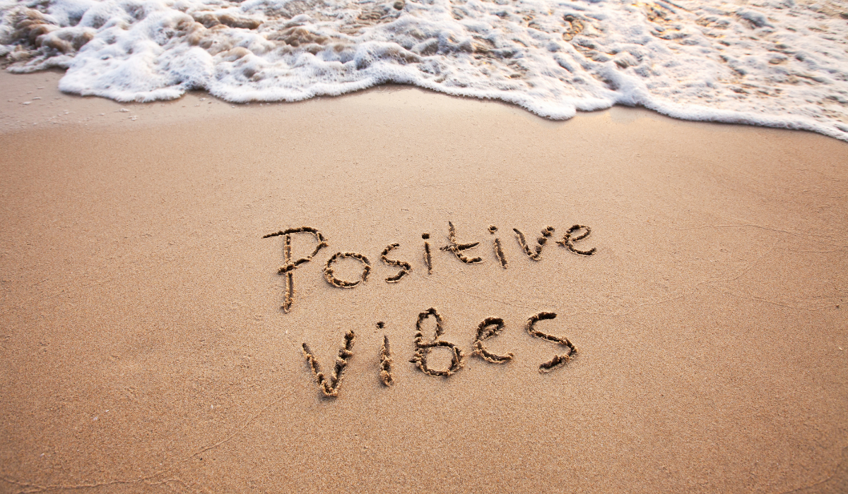Positive-Vibes-is-written-on-the-sandy-beach